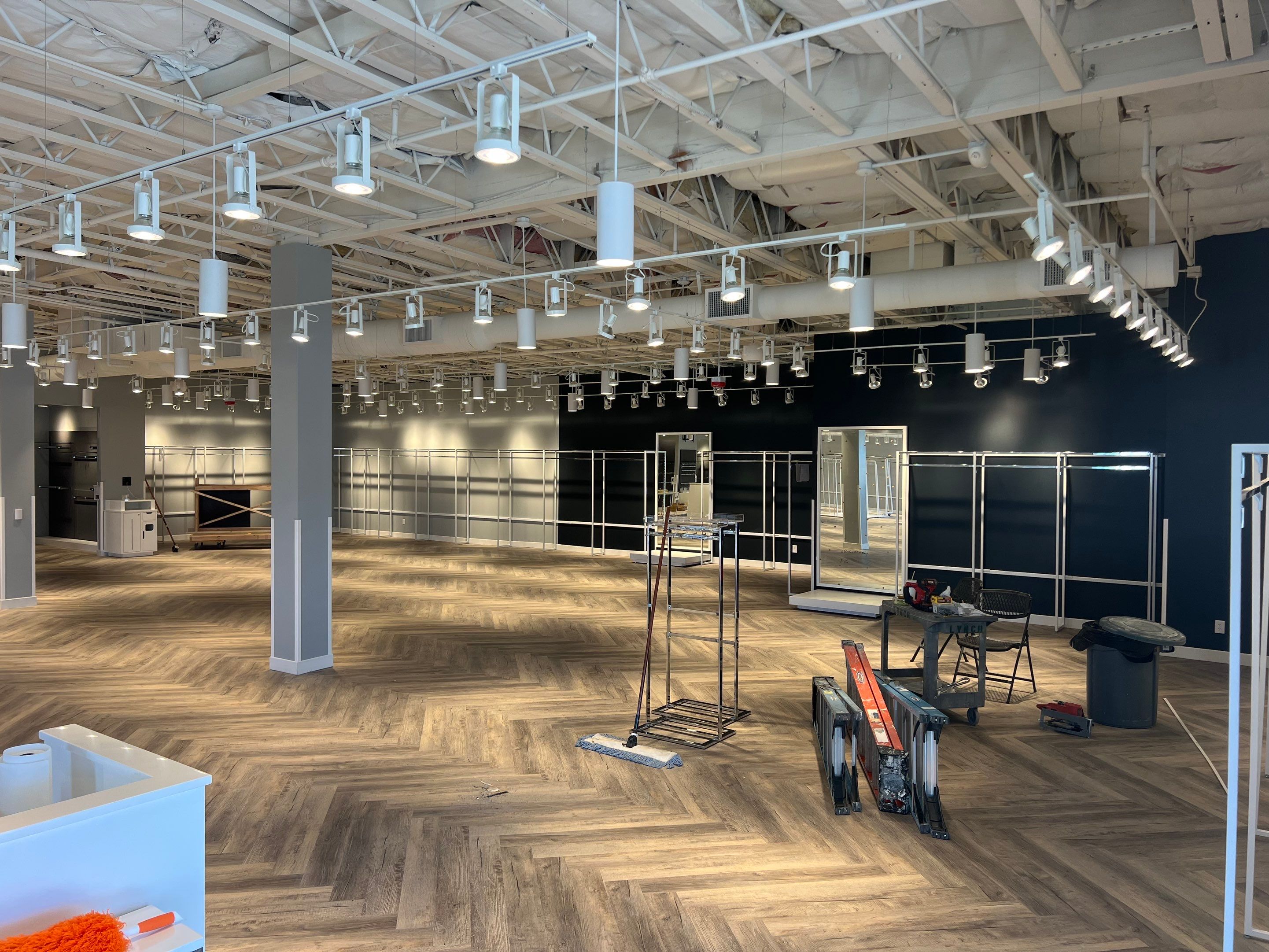 David's Bridal showroom buildout with herringbone flooring, fitting areas, and new track lighting