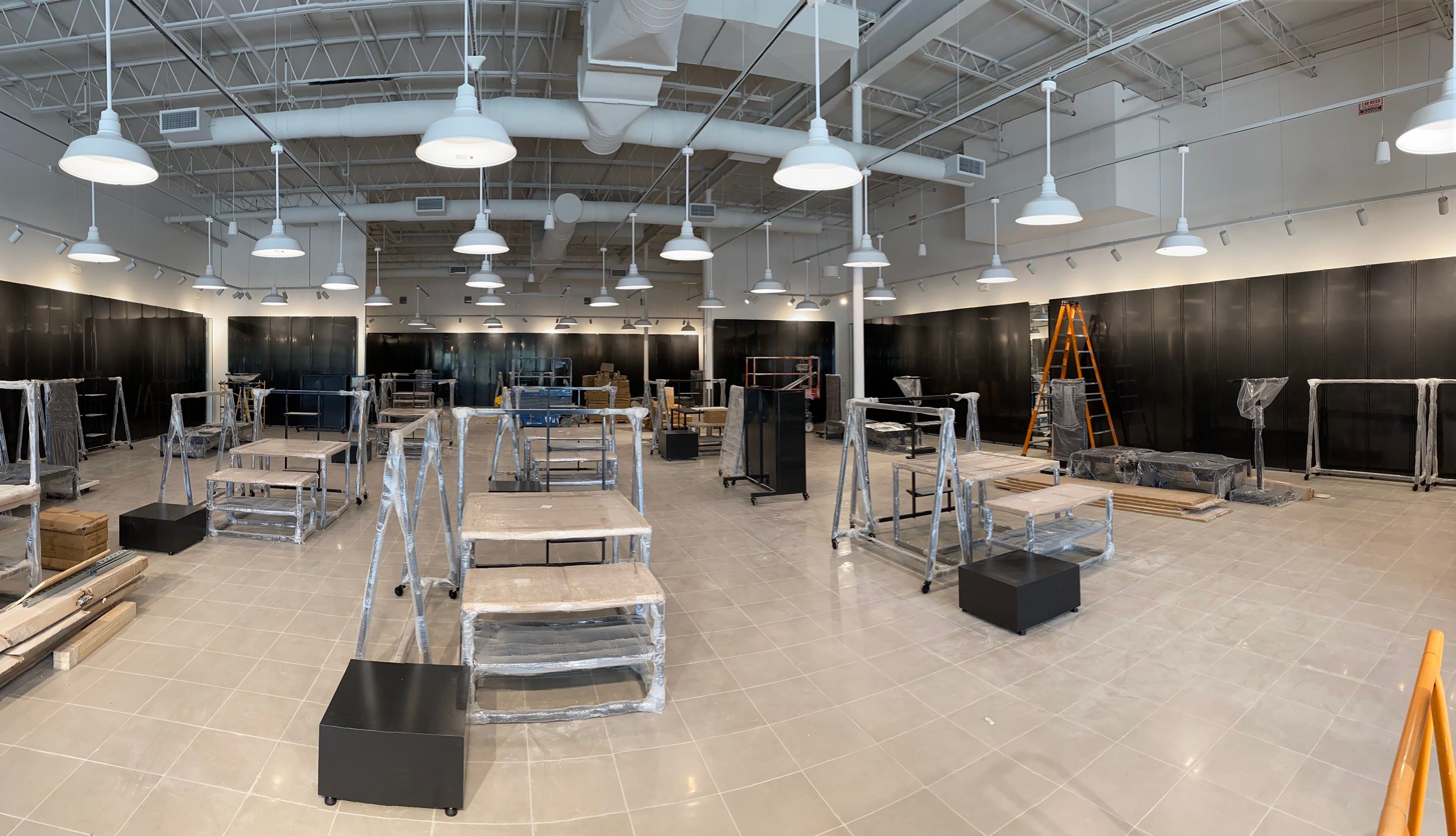 Foot Locker retail interior buildout with display fixtures and pendant lighting under installation
